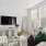 Living room with sectional, flat screen, large windows